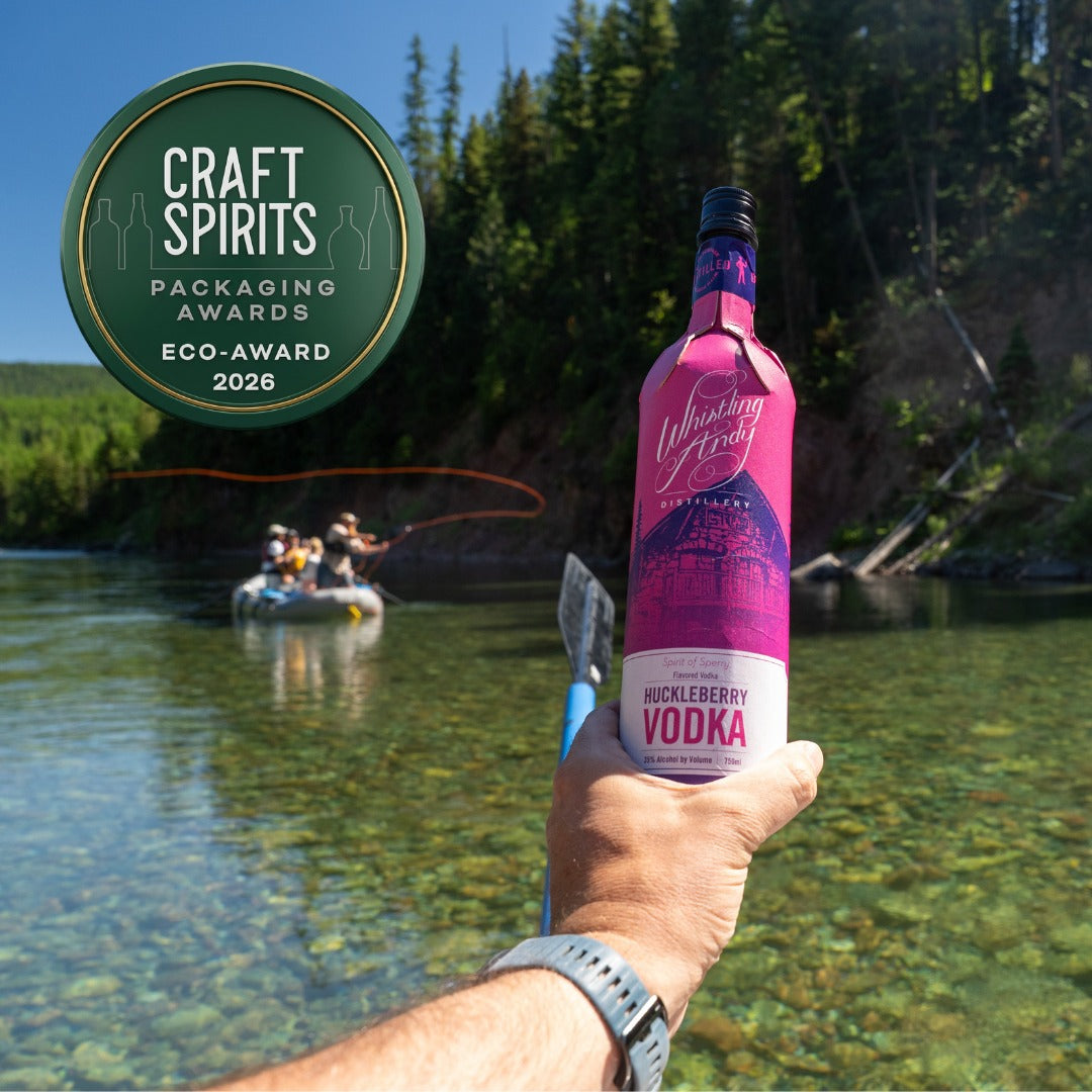 Whistling Andy Huckleberry Vodka paperboard bottle in Flathead Lake
